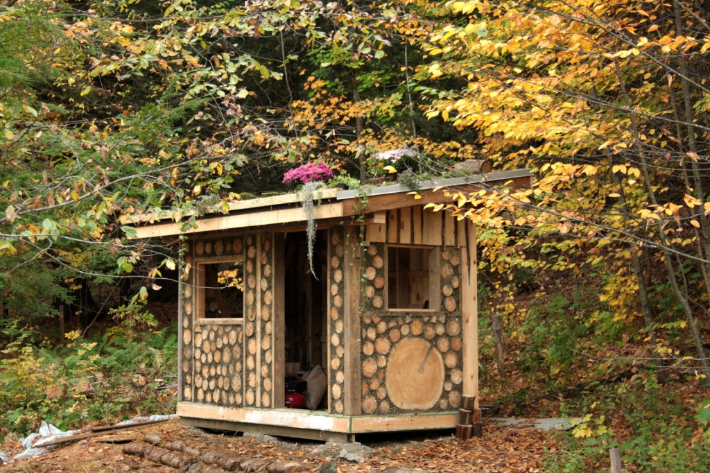 natural building tool shed made of wood and clay and straw